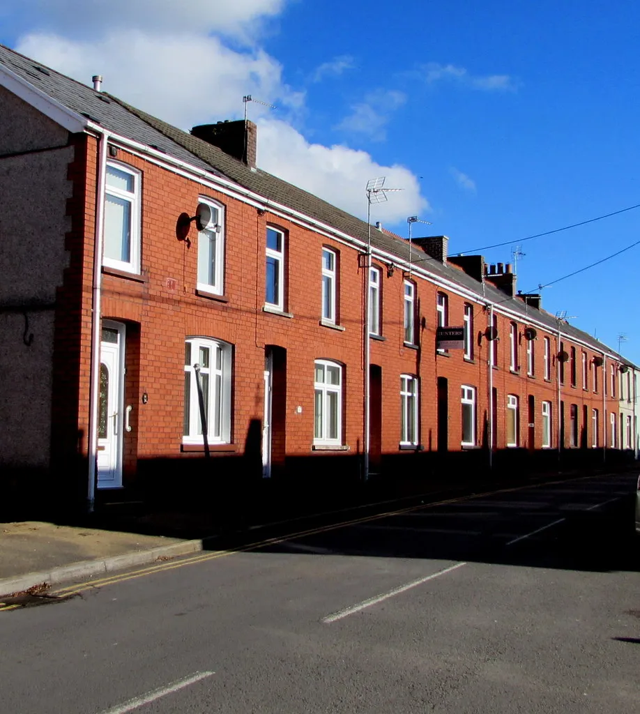 Row of brick terrace houses on a tree-lined Australian street